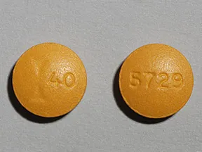 This medicine is a tan, round, film-coated, tablet imprinted with 