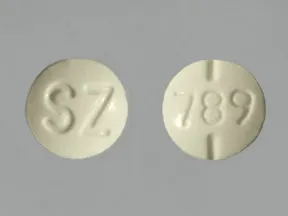 This medicine is a pale green, round, scored, tablet imprinted with 