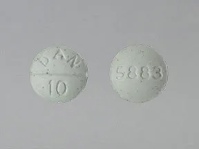 This medicine is a green, round, scored, tablet imprinted with 