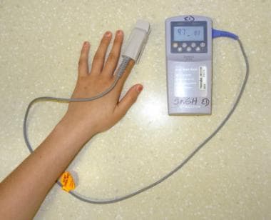 Portable pulse oximeter with finger probe. 