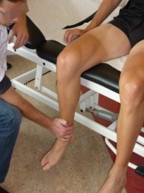 Examiner holds the knee in a steady position for i