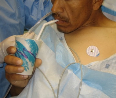 Patient flexing his neck and drinking water while 