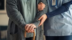 photo of  373 / 5,000 Senior nurse assistance with walking cane.