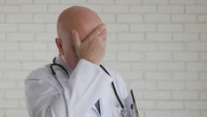 photo of Tired and Upset Doctor After a Long and Hard Working Day in Hospital.