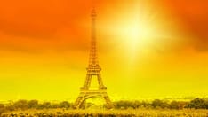 photo of Eiffel tower and bright sun on orange - heat wave in Paris, France