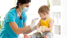 photo of Doctor holds an injection vaccination the child.