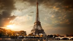 photo of Clouds over Paris. Eiffel Tower and bridge Iena on the river Seine in Paris, France.