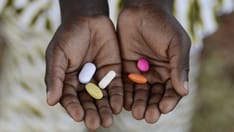 photo of Health and Healthcare: Curing Malaria - African Girl Holding Pills Medicine Health Symbol. Curing Malaria - African