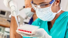 photo of Asian scientist performing a blood test in a medical research laboratory. Asian Indian female scientist or doctor us