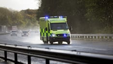 photo of A British ambulance responding to an emergency in dangerous driving conditions due to bad weather on a British motor