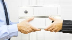 photo of Manager in public administration gives work to employee.