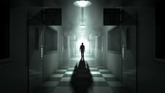 photo of Mental Asylum With Ghostly Figure. A ghostly figure casts a long shadow down the middle of a dimly lit passage of a 