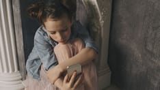 photo of kid on her phone