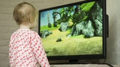 photo of kid watching tv