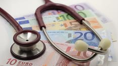 photo of money and stethoscope