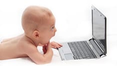 photo of cute baby on a laptop