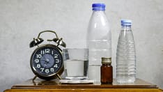 photo of alarm clock and water