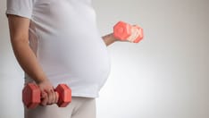 photo of pregnant woman lifting dumbells