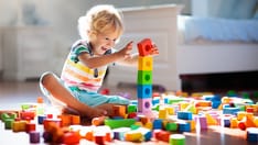 photo of kid playing with blocs