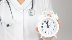 photo of doctor holding a clock