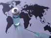 medicine vial and syringe on a world map