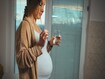 photo of a pregnant woman taking pills