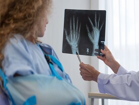 photo of doctor showing X-rays to patient