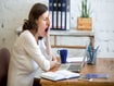 photo of tired woman working at a desk.