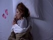 photo of Sad lady crying lying in bed and looking at baby socks near pillow, miscarriage