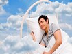 photo of Man sleeping on a bed in the clouds
