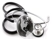 photo of Stethoscope next to glass globe world map