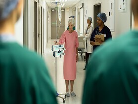 photo of Patient walking with IV Pole