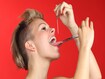 photo of Woman piercing the tongue herself