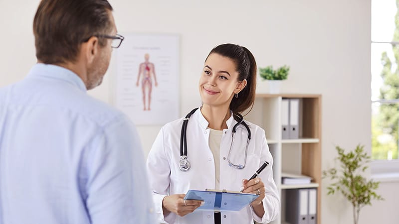 photo of young doctor talking with patient