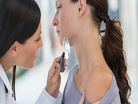 photo of a doctor examining the skin of a patient