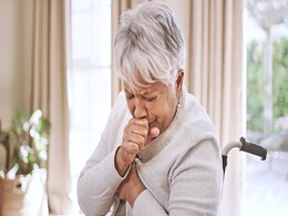 photo of a senior woman coughing
