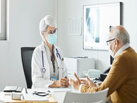 photo of a doctor speaking with a patient