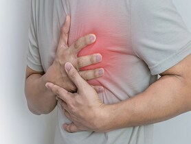 photo of man holding chest in pain