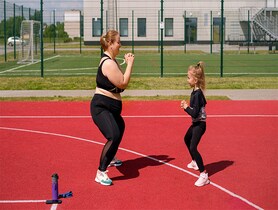 photo of Obese mom with kid exercising