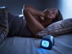 photo of girl with insomnia next to clock