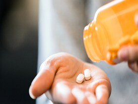 photo of woman taking pills