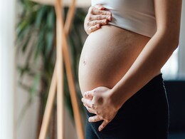 photo of Pregnant Woman Holding Her Belly