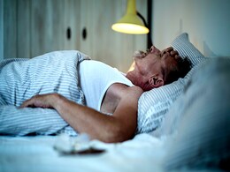 photo of Man sleepless in bed
