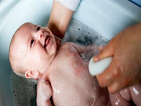 photo of bathing her baby boy in a tub