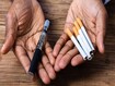 photo of Man Holding Vape And Tobacco Cigarettes