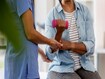 photo of An unrecognizable female doctor helps an 