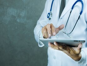 photo of Doctor holding tablet