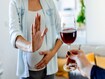 photo of Pregnant woman refusing a glass of wine