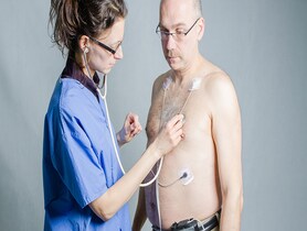photo of Nurse and man with holter monitor