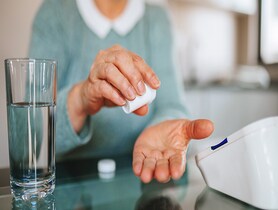 photo of woman taking medication